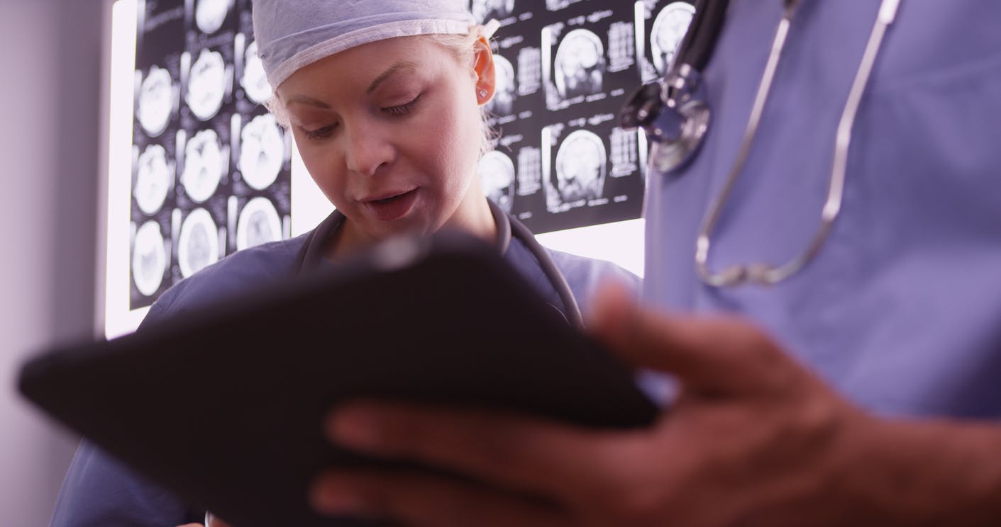 doctors looking at tablet