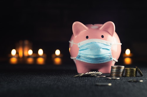 fake loan apps in Nigeria: A piggy bank wearing a face mask alongside some coins