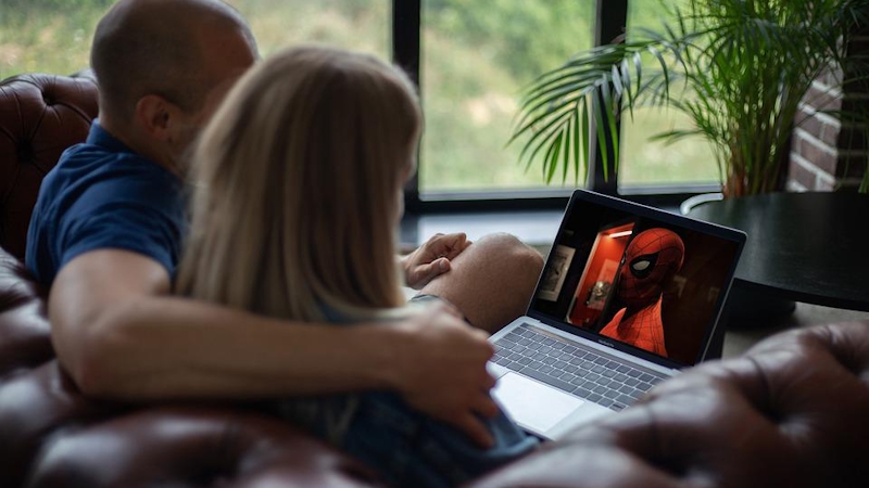 A couple watching a movie together.