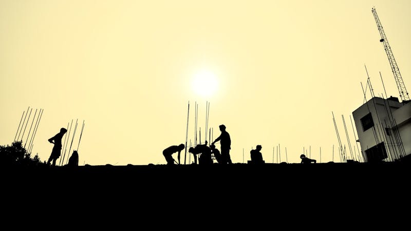Labourers work in silhouette with the sun in the background - businesses to start with 5k in Nigeria