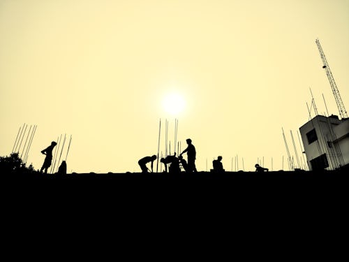 Labourers work in silhouette with the sun in the background - businesses to start with 5k in Nigeria