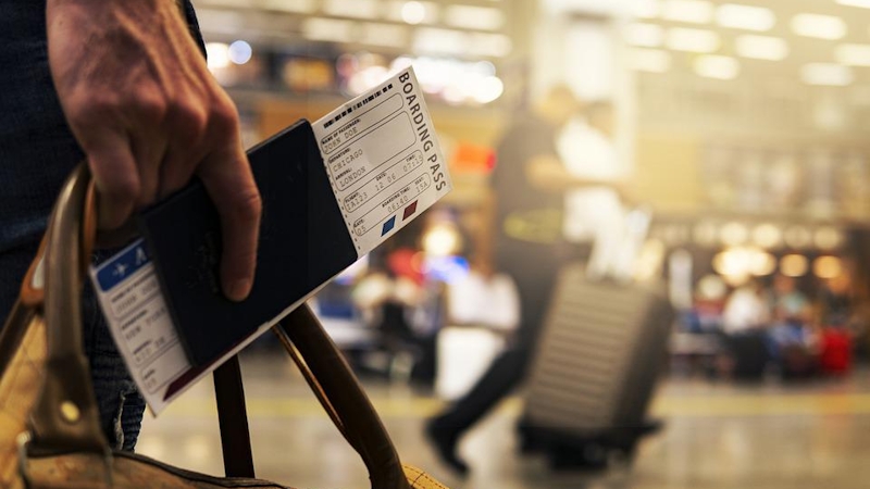 Man going on a business trip with his Bording Pass.