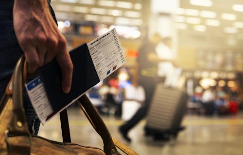 Man going on a business trip with his Bording Pass.