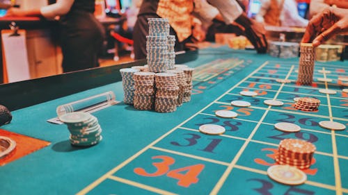 Image showing cards placed on a casino table surrounded by players