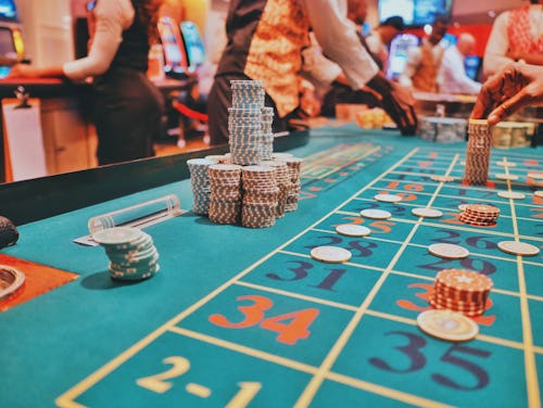 Image showing cards placed on a casino table surrounded by players