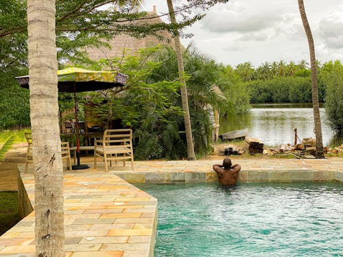 Image of a man in a swimming pool in a resort