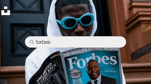 Image showing a man reading Forbes magazine on richest people in the world