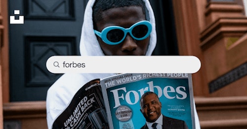 Image showing a man reading Forbes magazine on richest people in the world