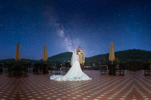 Image of a bride and a groom at holding a destination wedding under the stars