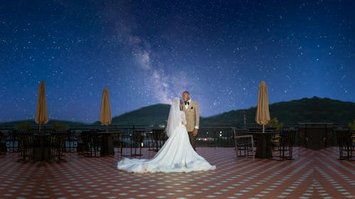 Image of a bride and a groom at holding a destination wedding under the stars