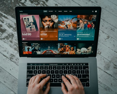 Image showing a person on a laptop showing movies on an online streaming platform, Hulu