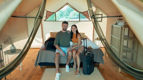 A couple on a honeymoon inside a chalet with their luggage