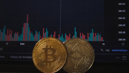 Bitcoin and Ethereum placed side by side in front of a chart