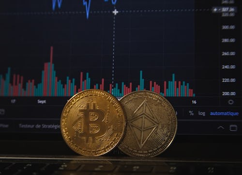 Bitcoin and Ethereum placed side by side in front of a chart