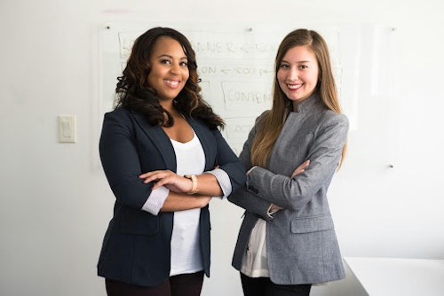 image showing two women wearing suit at work