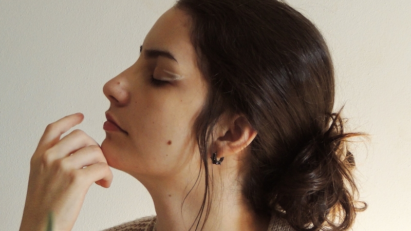 A woman scenting well after using a long lasting perfume
