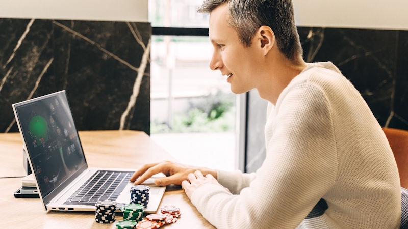 A man pressing laptop and gambling online