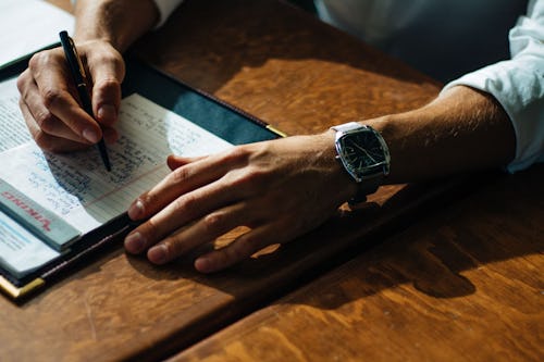 A person writing on a paper.