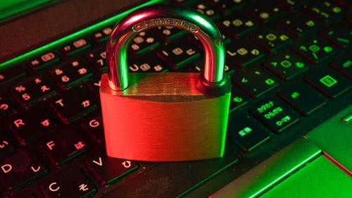 A pad lock sits atop the keyboard of a laptop