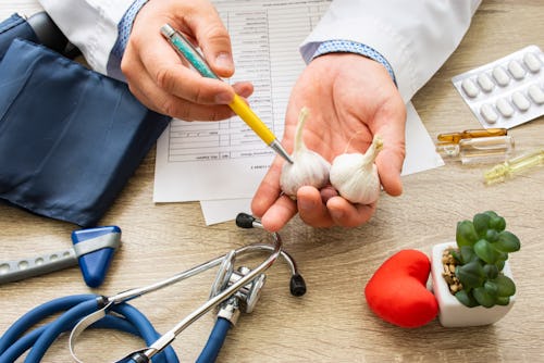 A doctor holding garlic gloves