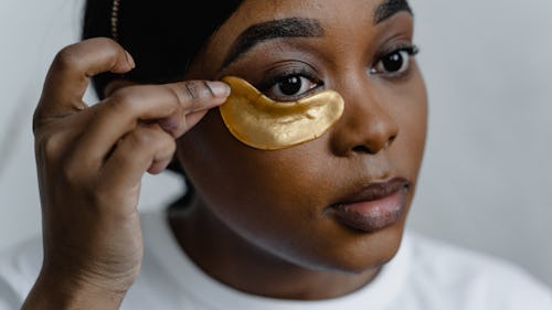 A black woman with drawn eyebrows wearing an eye mask