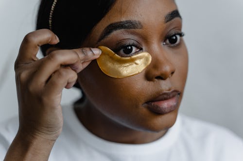 A black woman with drawn eyebrows wearing an eye mask