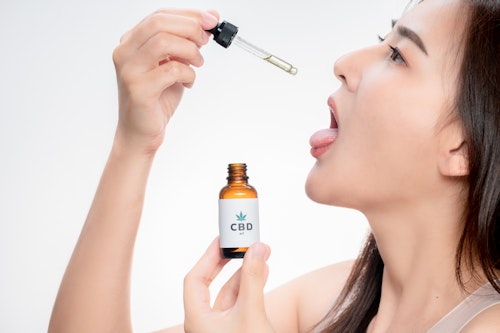 A White woman taking cbd oil