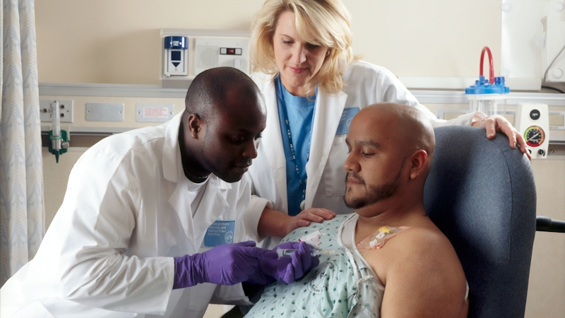 Doctor and oncologist examining a patient with a benign tumor