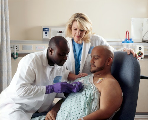 Doctor and oncologist examining a patient with a benign tumor