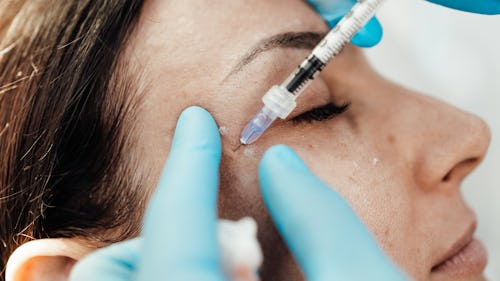A woman getting an injection on the face for facial skincare