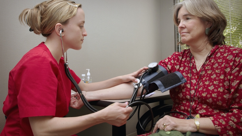 A nurse checking a patient's blood pressure