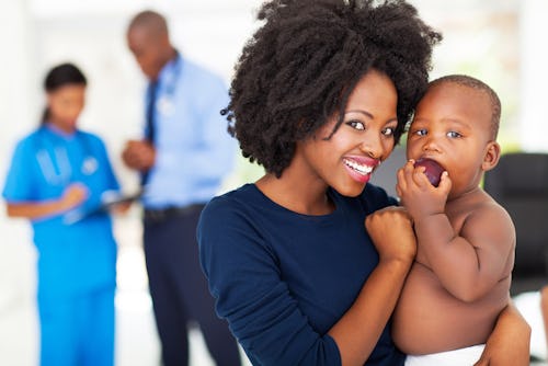 A Nigerian mother treating her sick baby in a hospital facility registered under her HMO