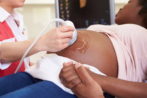 A radiologist carrying out an ultrasound scan on a pregnant woman