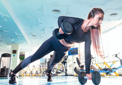 Exercise: A bodybuilder working out with dumbbells at the gym