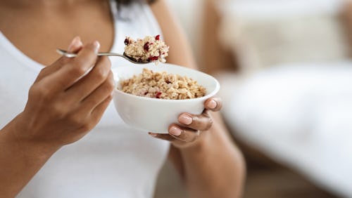 A woman eating oatmeal, a healthy meal and a good snack option for people with diabetes