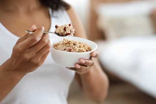 A woman eating oatmeal, a healthy meal and a good snack option for people with diabetes