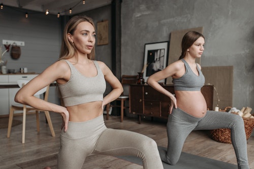A pregnant woman doing prenatal yoga
