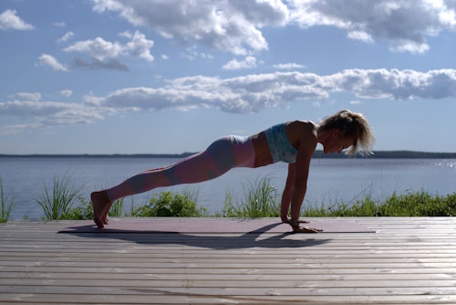 A woman exercising by the seashore