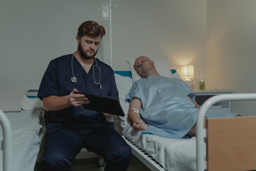 A white Doctor treating a male cancer patient