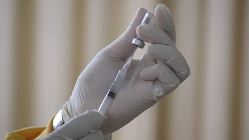 A healthcare provider giving coronavirus vaccine booster