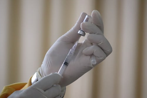 A healthcare provider giving coronavirus vaccine booster