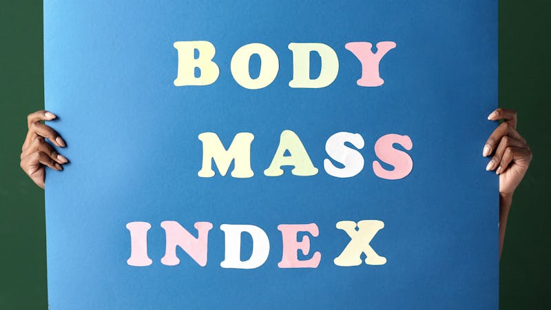 A woman carrying a placard written "body mass index"