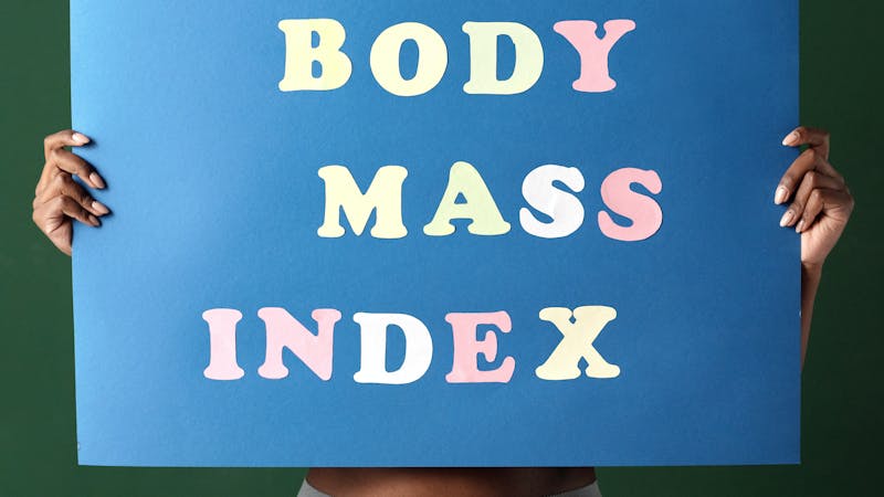 A woman carrying a placard written "body mass index"