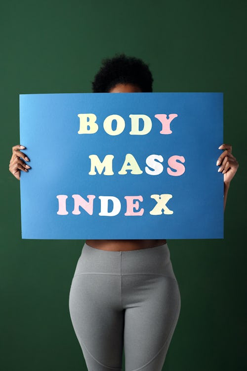 A woman carrying a placard written "body mass index"