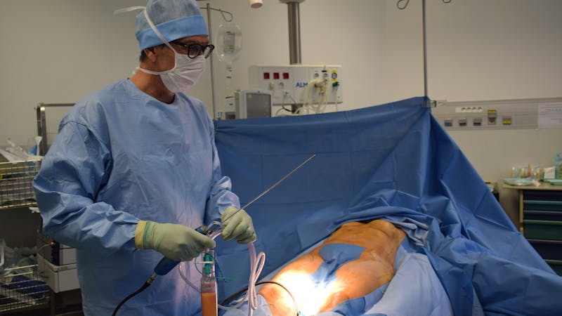 A plastic surgeon carrying out surgical operation on a patient