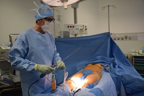 A plastic surgeon carrying out surgical operation on a patient