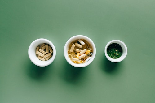 Three plates containing different supplement pills 