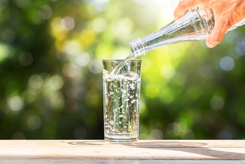 A man pouring out drinking water