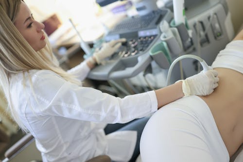 Image of a doctor performing pelvic scan on a patient to check the kidneys