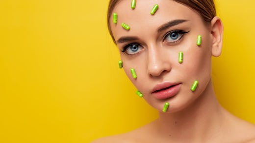 Picture of a lady with tablet pills placed on various parts of her face